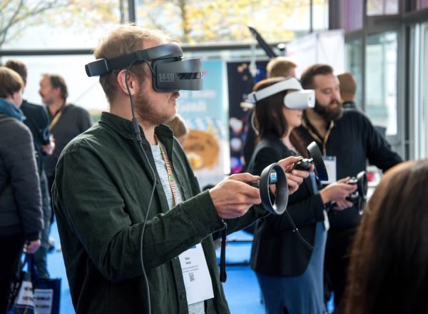 person wearing VR smartphone headset inside room